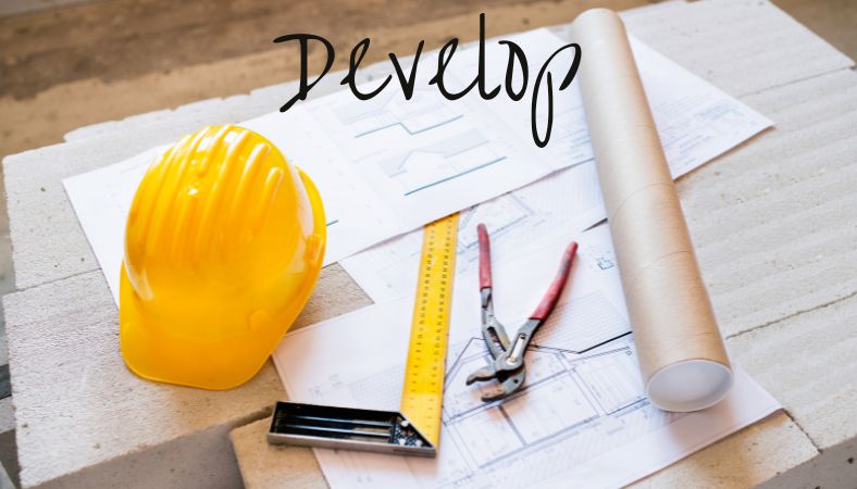 image of hard hat with building plans
