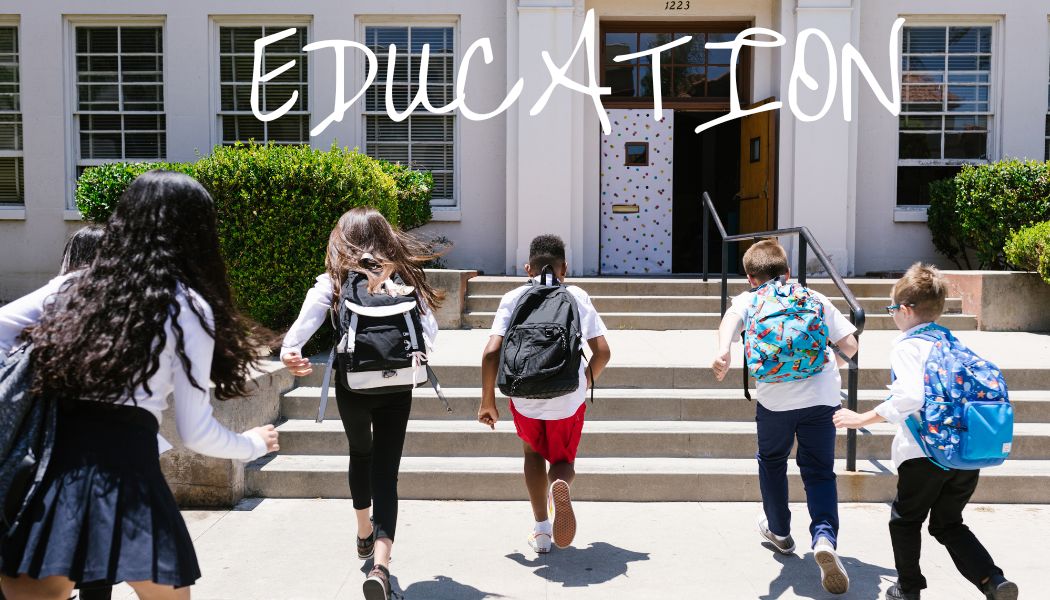 children running into a school with back packs on